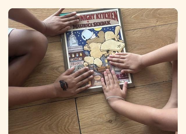 Children's hands on a picture book during story circle
